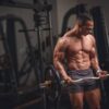 Athlete lifting weights in a gym, showcasing fitness training results.